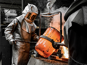Foundry worker casting molten metal